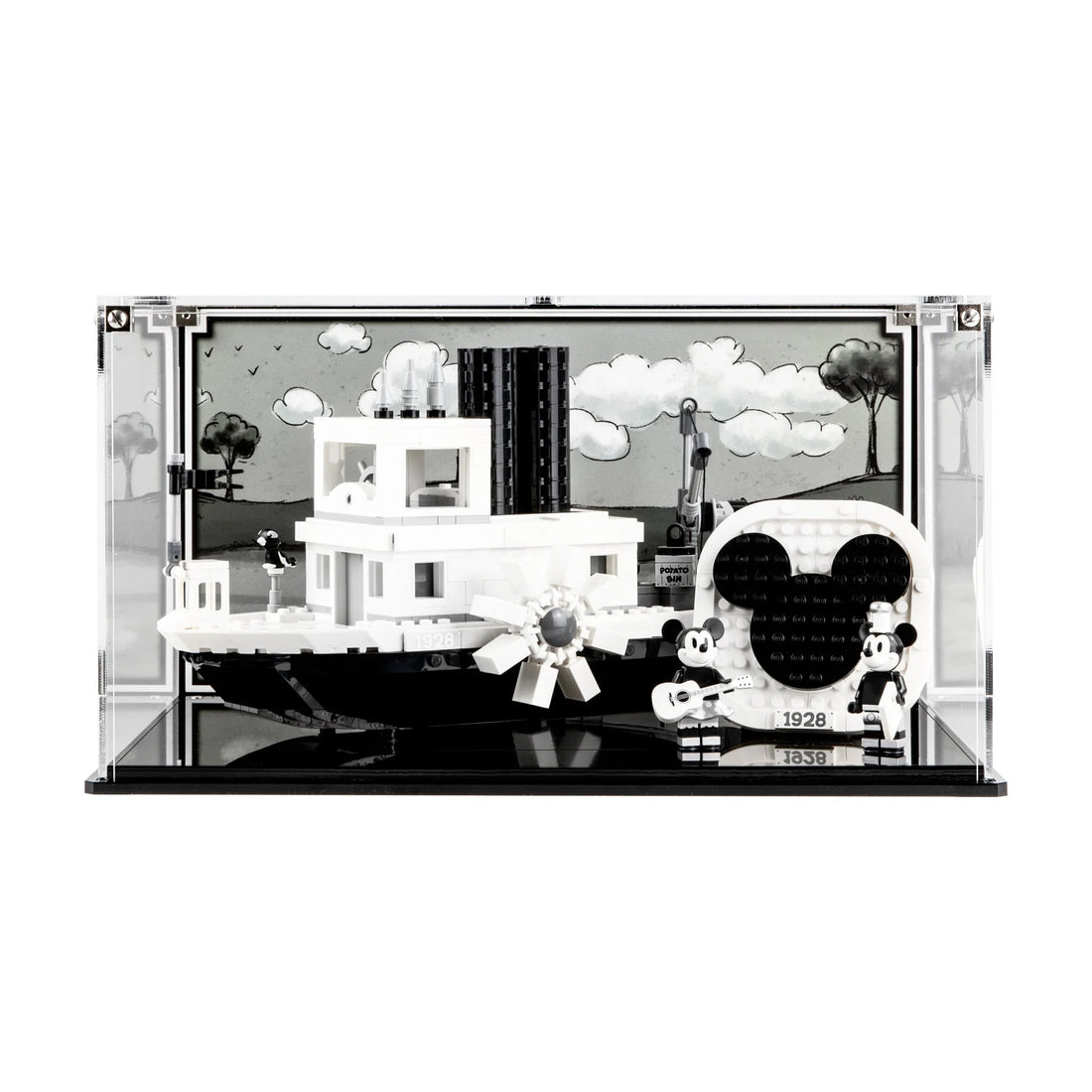 Black-and-white LEGO Steamboat Willie 21317 inside a clear case with character figures beside the boat