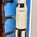 Middle detail of wall-mounted display frame for LEGO® NASA Apollo Saturn V (21309), showing clear retaining clips around rocket