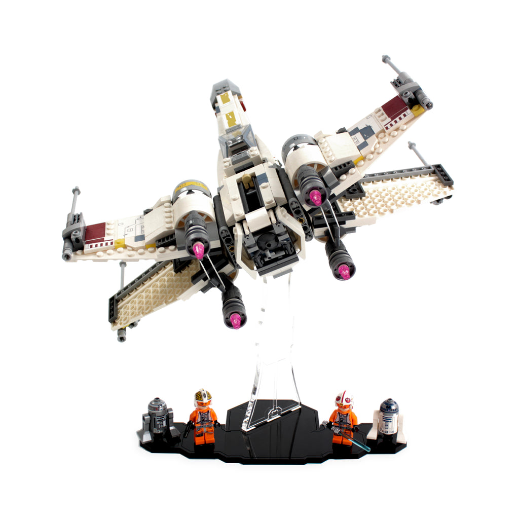 LEGO X-wing Starfighter 75218 tilted on a clear display stand with minifigures