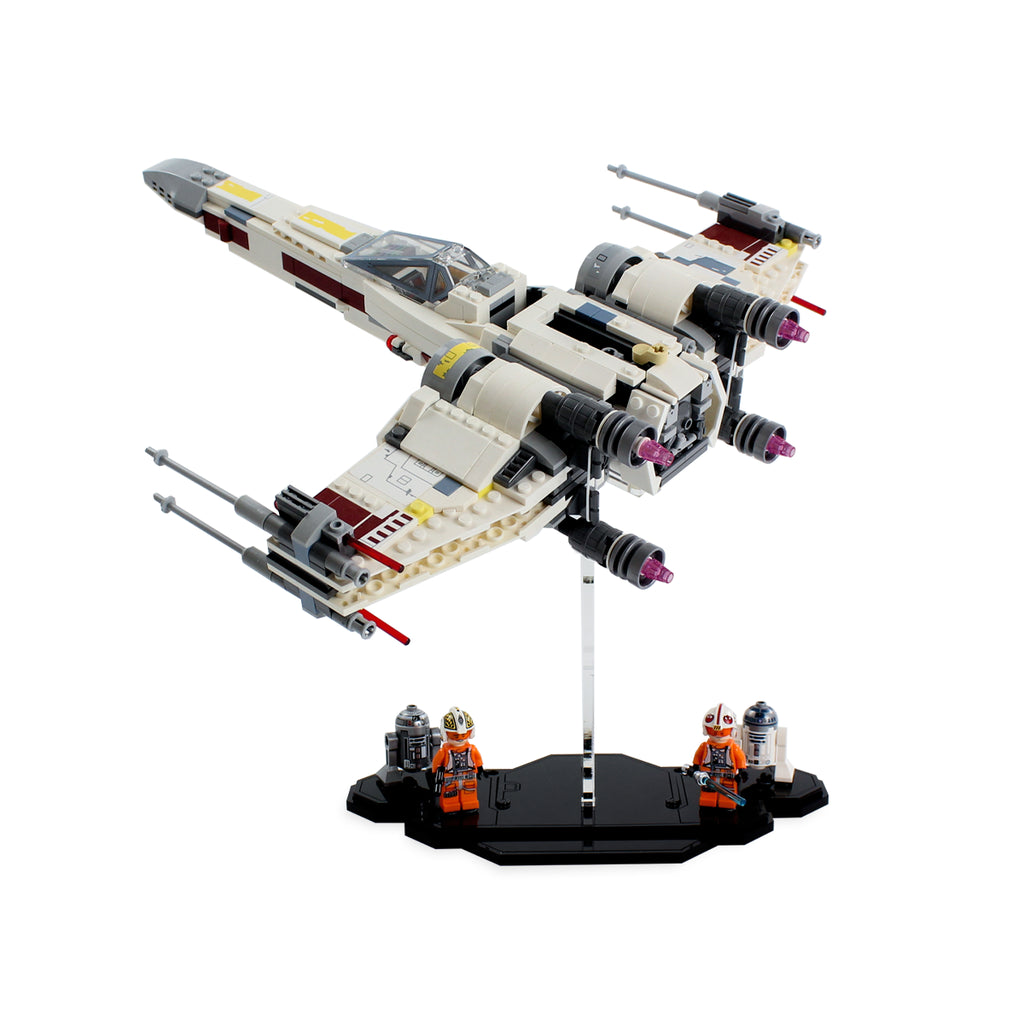 Alternate angle of LEGO X-wing Starfighter 75218 above the black minifigure base