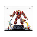 Front view of the complete acrylic display case with LEGO 76105 Hulkbuster and workshop