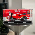 Front view of the acrylic display case for LEGO Ferrari F2004 and Michael Schumacher 11375, with printed racing backdrop.