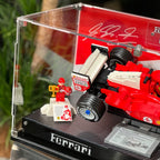 Close view of the LEGO 11375 Ferrari F2004 and Michael Schumacher display inside the acrylic case.