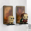 Angled view of paired wall-mounted displays for LEGO BrickHeadz Frodo and Gollum 40630, with orange map backgrounds.