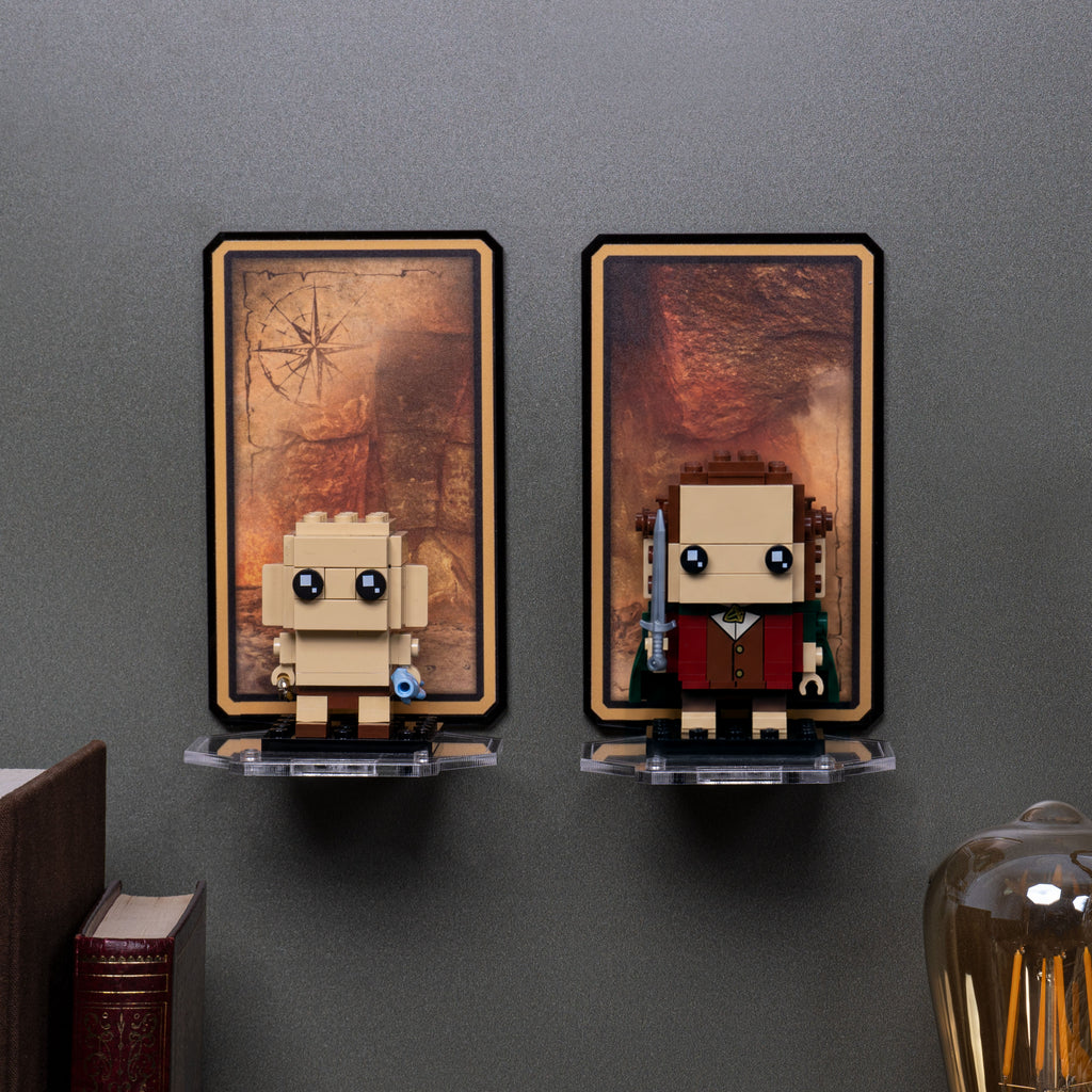 Frodo and Gollum 40630 displayed on separate wall-mounted shelves against a gray wall.
