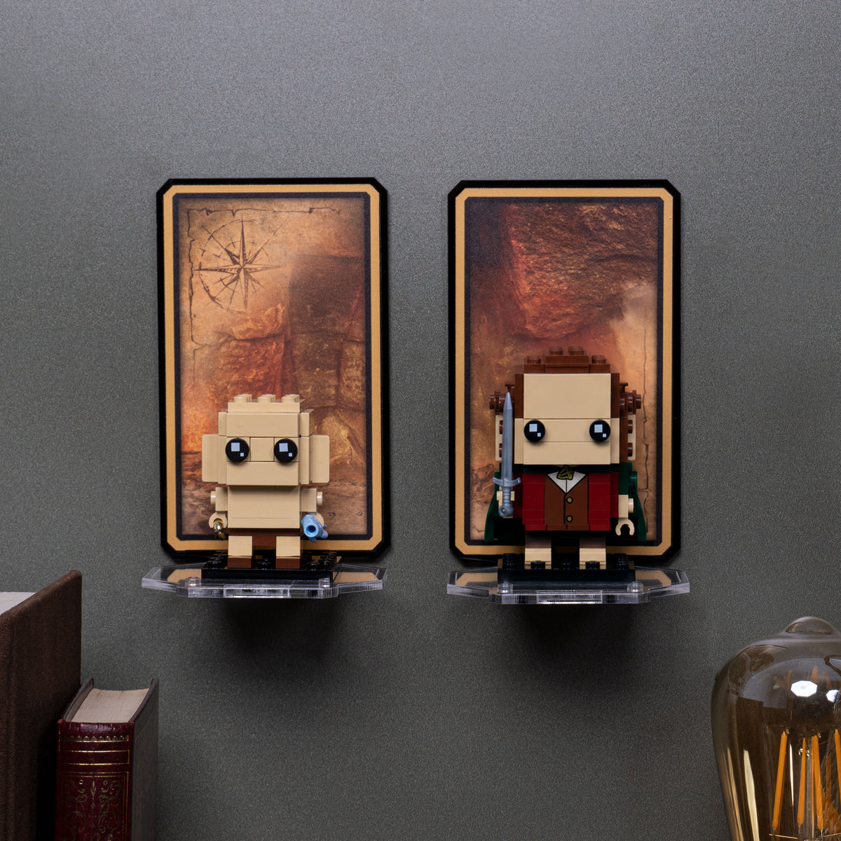 Frodo and Gollum 40630 displayed on separate wall-mounted shelves against a gray wall.