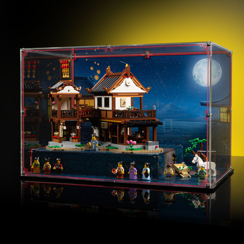 Angled view of an acrylic display case for LEGO Ancient Moon-Gazing Inn 80121 with a raised base and moonlit backdrop.