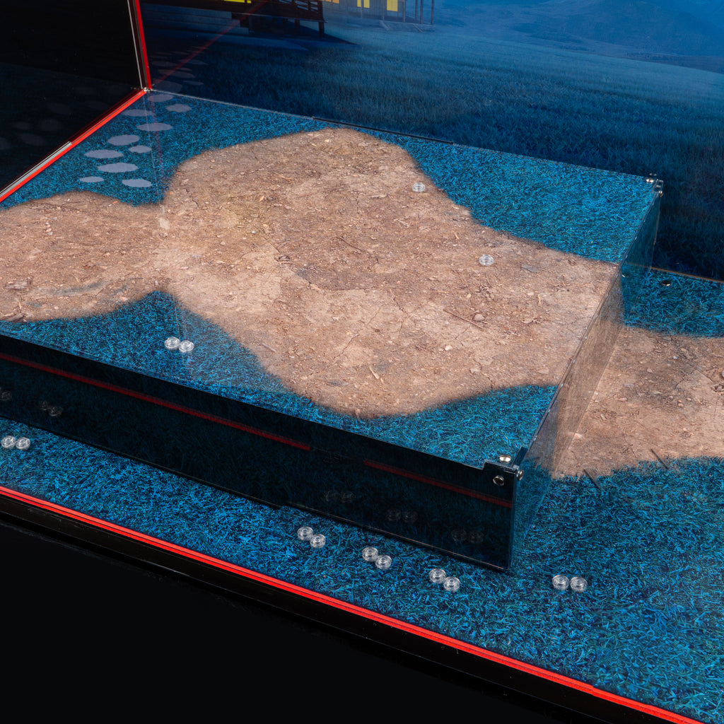 Close-up of the raised platform, stone-path print and minifigure locator studs in the LEGO 80121 display case.