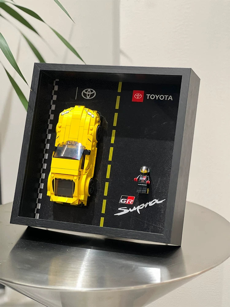 Single-car display frame compatible with LEGO 76901 - Toyota GR Supra. Car and minifigures not included.