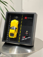 Single-car display frame compatible with LEGO 76901 - Toyota GR Supra. Car and minifigures not included.
